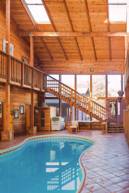 Two-story California home interior with indoor swimming pool 