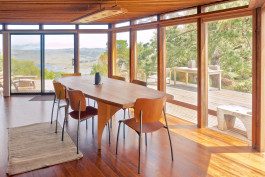 Home dining room with large windows showing sweeping views of the Inverness, California landscape 